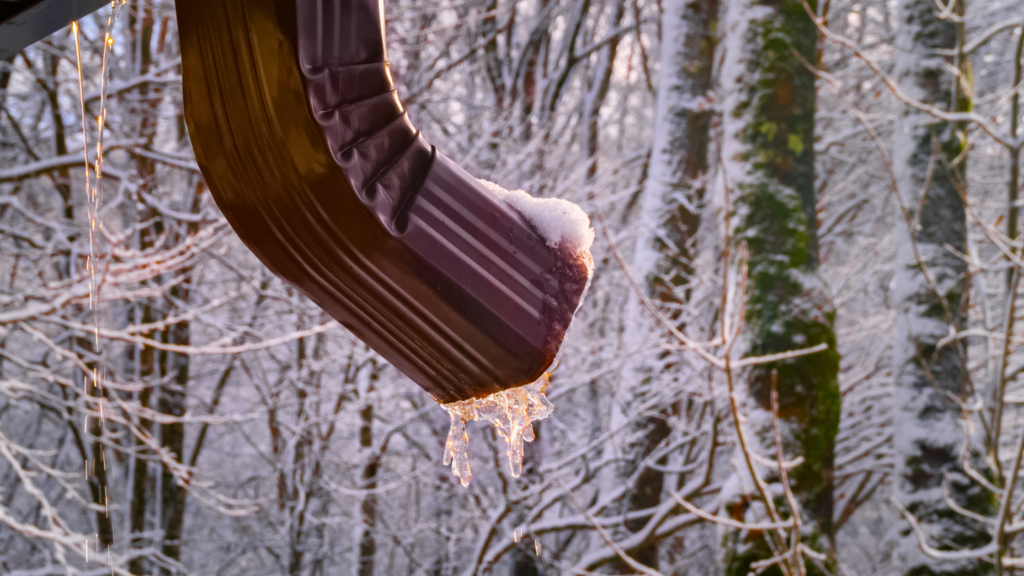 gutter of home frozen with ice during the Winter