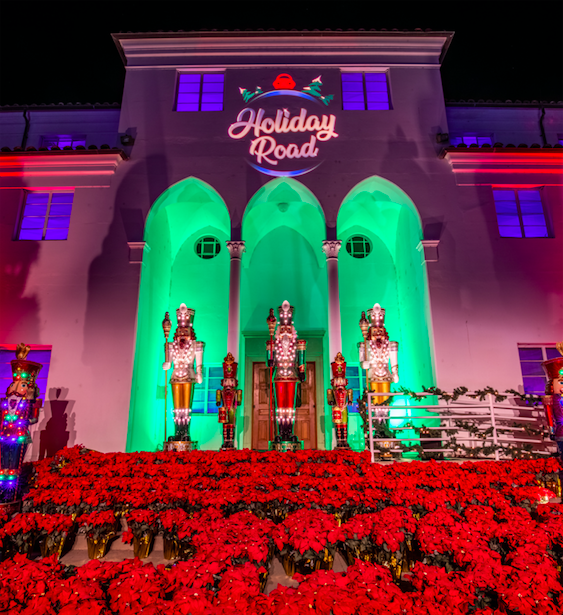 3 huge nutcrackers with rows of poinsettias at their feet